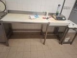 a kitchen with a table and a stove in it