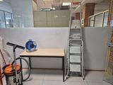 a room with a ladder, a table, and a chair in it