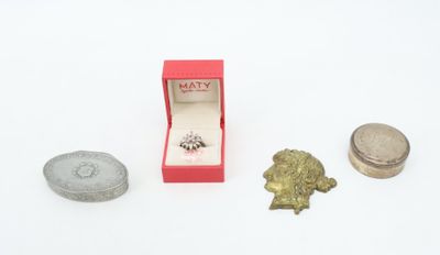 a small box with a ring in it next to a coin and a ring box