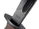 a close up of a knife with a wooden handle