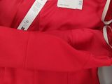 a close up of a red dress with a label on it
