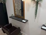 an image of a salon with a chair and a mirror