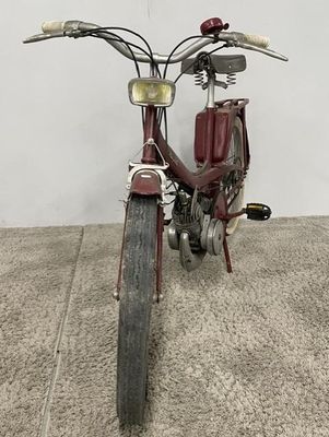 a red motorcycle that is parked on the concrete