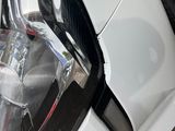 a close up of a car ' s headlight on the side of the road