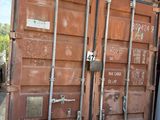a man standing next to a large container on a trailer