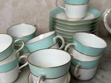 many cups and saucers that are sitting on a table