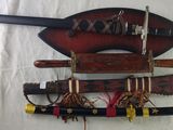 several different types of weapons are hanging on a wall