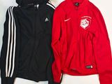 pair of red and black jackets sitting on top of a white table