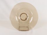 a glass plate with a ring on it on a white surface