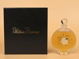 an image of a bottle of perfume sitting next to a box