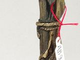 a statue of a bird on a stick with a price tag on it