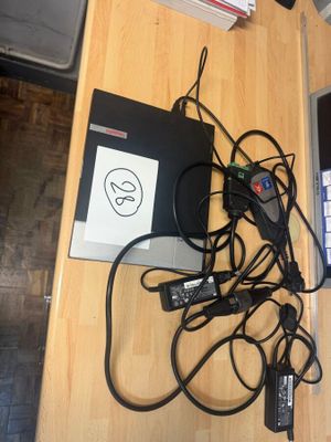 a table with a laptop and a bunch of wires