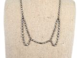 a close up of a necklace on a mannequin mannequin