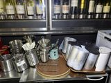 many pots and pans on the counter in the kitchen