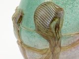 a vase with a seahorse on it sitting on a table