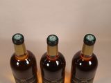 three bottles of wine that are sitting on a table