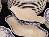 a lot of plates and bowls that are on a table