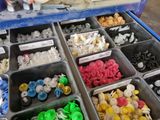 many different types of plastic buttons in the trays