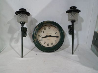 a clock that is sitting next to a candle holder