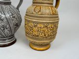 two vases sitting side by side on a white surface