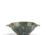 a close up of a bowl with a handle on a white background