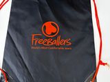 a black bag with a logo on it sitting in a box