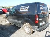 a van that is parked in a lot with other cars