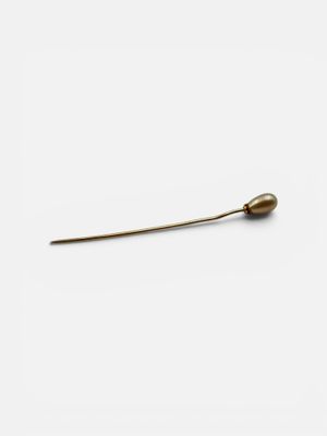 an image of a small metal object on a white surface