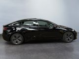 an image of a black tesla model s in a showroom