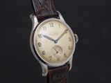 a close up of a wrist watch with a brown leather strap