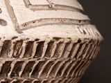 a close up of a vase with a pattern on it