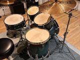 a drum set that is sitting on a rug in a room