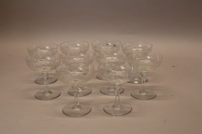several empty wine glasses are lined up on a white surface