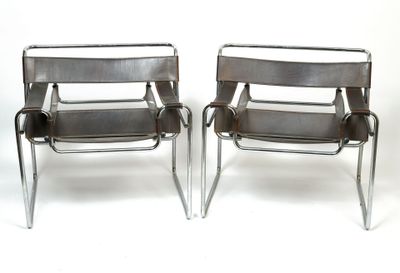 pair of chrome steel and leather chairs with arm rests on a white background