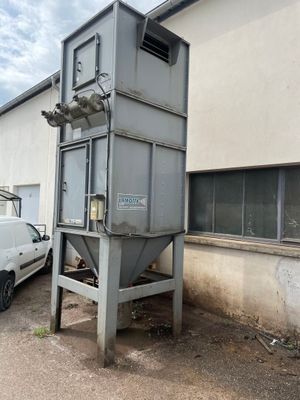 a truck parked next to a building with a machine on it