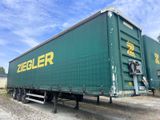 une semi-remorque verte garée sur le bord de la route