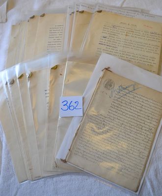 a lot of old papers that are on a bed