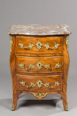an antique wooden chest of drawers with marble top
