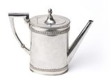 an old silver teapot on a white background with a metal handle