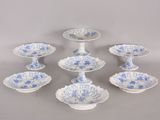 six blue and white plates with blue flowers on them