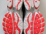 the soles of a pair of running shoes on a white surface