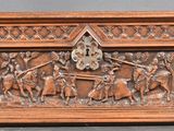 an old wooden box with carvings of people and animals on it