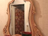 a mirror and a bowl on a table in a room