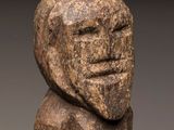a close up of a stone statue of a person with a face