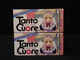 two boxes of tanto cuore on a black surface