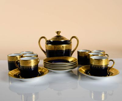 several cups and saucers are sitting on a white table