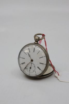 a small silver pocket watch with a tag attached to it