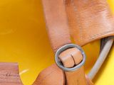 a yellow hard hat with a leather strap on it
