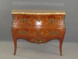 a small chest of drawers with a marble top