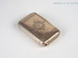 a small silver book sitting on a white surface